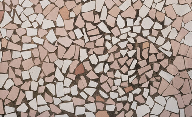 Background from pieces of tiles of different colors. The tiles are laid out on the wall. Imitation of phono tiles
