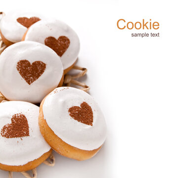 Homemade cookies with white cream and a drawing of the heart