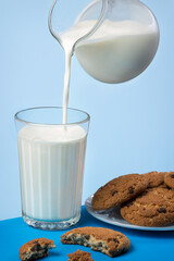 Glass of milk with cookies on a plate