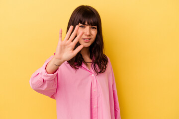 Young caucasian woman isolated on yellow background being shocked due to an imminent danger