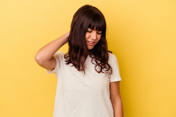 Young caucasian woman isolated on yellow background having a neck pain due to stress, massaging and touching it with hand.