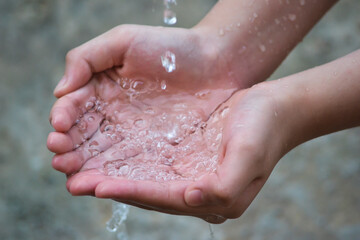raised hands to catch the water