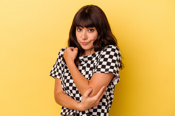 Young caucasian woman isolated on yellow background confused, feels doubtful and unsure.