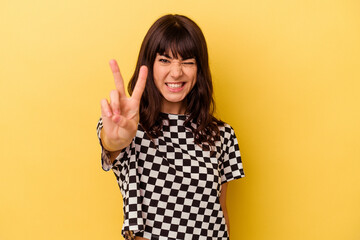 Young caucasian woman isolated on yellow background showing number two with fingers.