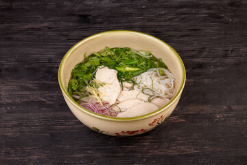 soup with chicken meat, rice noodles, dill, parsley, green onions, served with ginger
