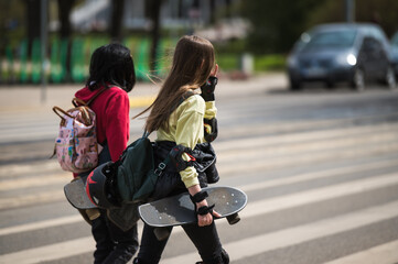 Teenagers with skateboards on crosswalk
