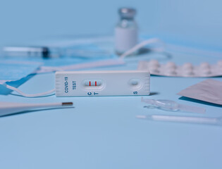 Express COVID-19 test,Schnelltest, medical mask, syringe,thermometer,medicine on a blue...