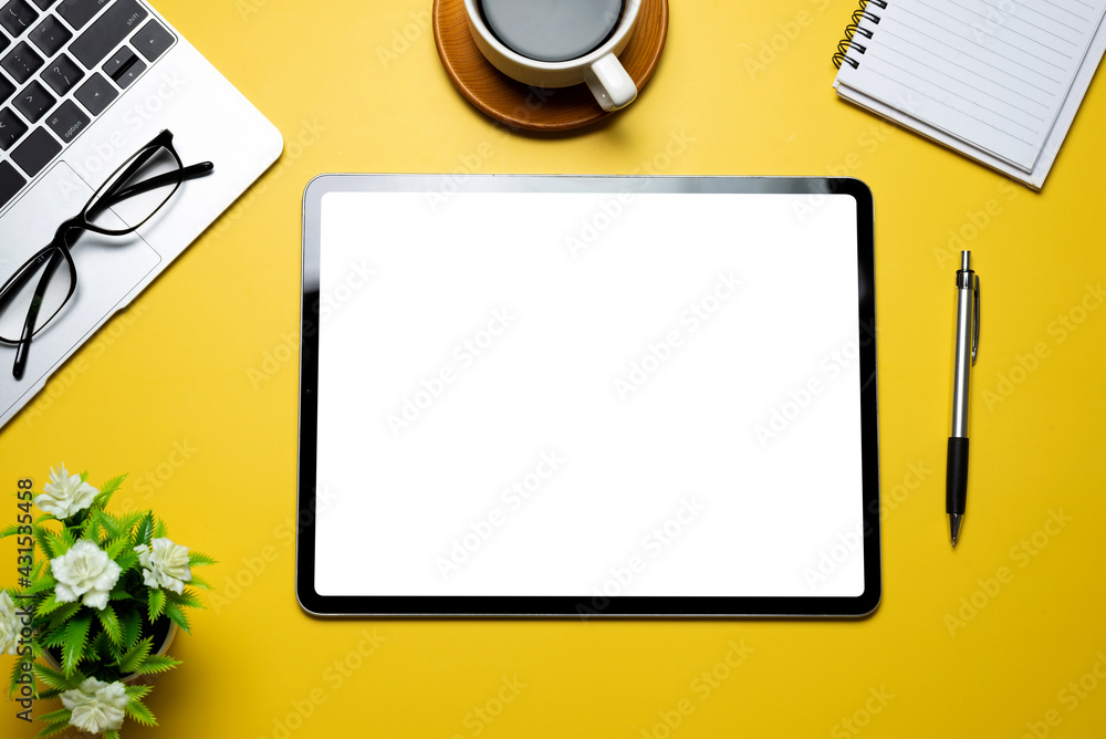 Poster top view yellow workspace with tablet blank white screen coffee keyboard glasses notebook placed on 