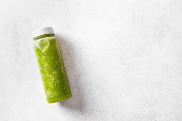 Green smoothie in plastic bottle