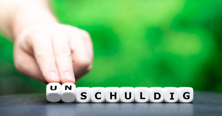 Hand turns dice and changes the German word 