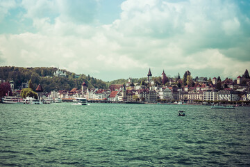 Small sailing boat on the lake of Luzern, with snowy mountains in the background, shot in Luzern, switzerland