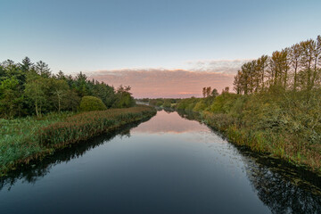 Naklejka na ściany i meble Clear sky morning on Inny river with reflections of sky, trees.