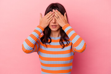 Young caucasian woman isolated on pink background afraid covering eyes with hands.