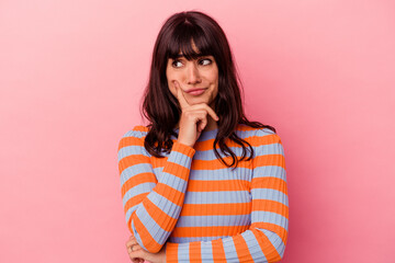 Young caucasian woman isolated on pink background contemplating, planning a strategy, thinking about the way of a business.