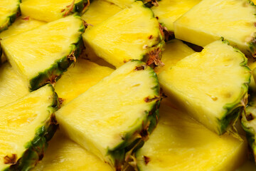 Pineapple juicy yellow slices background. Top view.