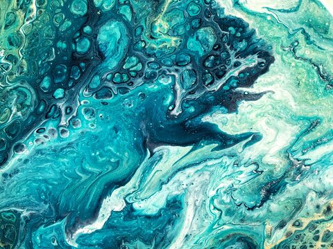 Fluid abstract acrylic painting. Mixed gold, green, blue paint. Epoxy resin art, pour painting, marble texture 