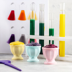 Hair color laboratory, samples of hair paints, brushes and test tubes on grey background, hairdresser tools