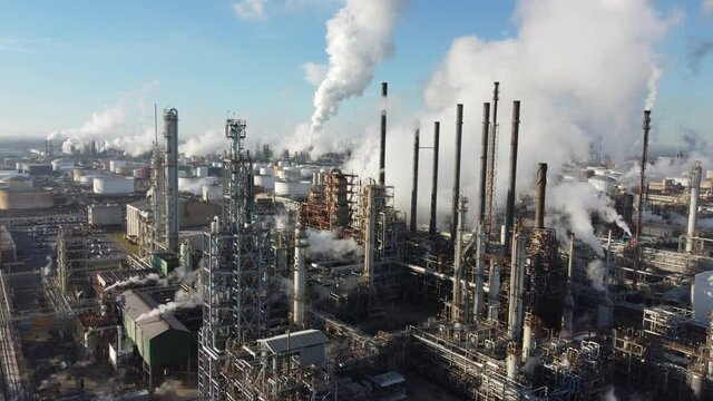 2020 - amazing rising aerial over a huge oil refinery along the Mississippi River in Louisiana suggests industry, industrial, pollution. 