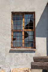 Old broken window in the stone wall. 