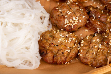 fried sesame cutlets served with rice noodles
