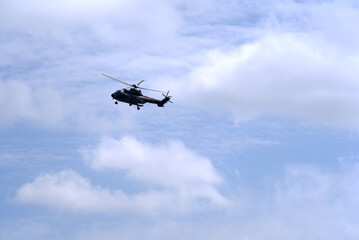 Swiss Air Force helicopter up in the air at Zurich Airport. Photo taken April 30th, 2021, Kloten, Switzerland.