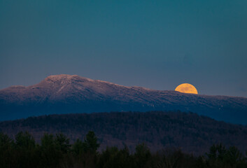 super moon rising over Mount Mansfield in the Green Mountains of Vermont
