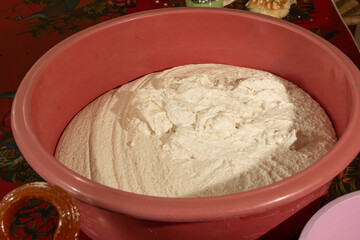 Dough for tamales on a plastic container, tamales are a traditional Mexican food.