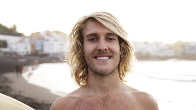 Authentic shot of young surfer man having fun outdoors after surf session - Extreme water sports concept