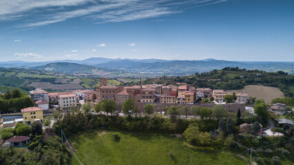 Fototapeta na wymiar Italy, May 2021: aerial view of the medieval village of Sant'angelo in Lizzola in the province of Pesaro and Urbino in the Marche region. Around the hills of the Marche