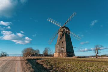 Fototapeta na wymiar Old windmills at the edge of the rural road..