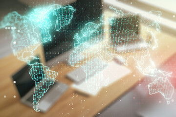 Double exposure of abstract digital world map and modern desktop with laptop on background, research and strategy concept