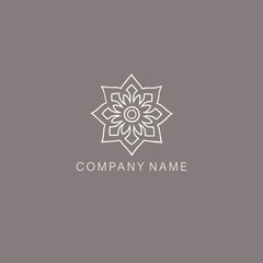 An Asian, stylized symbol or logo of the lotus flower, consisting of several elements. Made with a curved thin contour line.