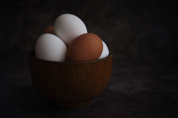 white and brown chicken eggs in the bowl