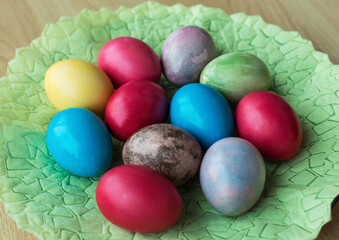 Fototapeta na wymiar Colorful painted eggs for easter on a green napkin
