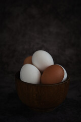 white and brown chicken eggs in the bowl