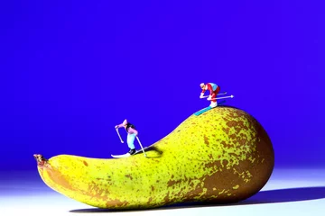 Foto auf Acrylglas Miniature figure people skiing on a fresh pear © Andrew Gardner