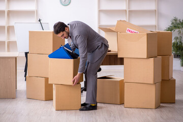 Young male employee in relocation concept