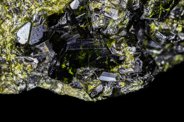 Closeup of Epidote crystal cluster. Larger black and green specimen, surrounded by smaller crystals. From Pakistan.
