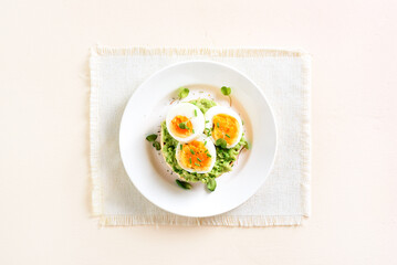 Bun with avocado and eggs