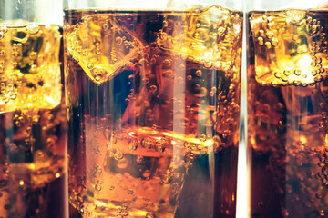 Refreshing Bubbly Soda Pop with Ice Cubes. Cold soda iced drink in a glasses - Selective focus, shallow DOF