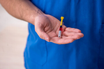 Young male doctor in vaccination concept during pandemic