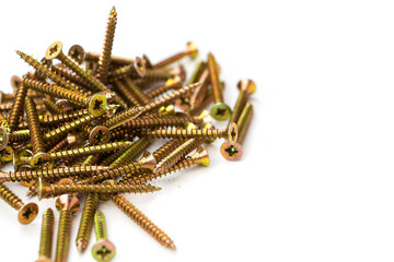 yellow self-tapping screw on a white background. A large number of screws.