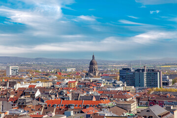 Fototapeta na wymiar Aerial view of the City of Mainz, Germany on blue clouds sky. Christuskirche - Cathedral. Feldberg mountain in background