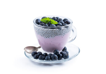 Fototapeta na wymiar Purple blueberry yogurt with fresh berries chia seeds in glass cup isolated on white