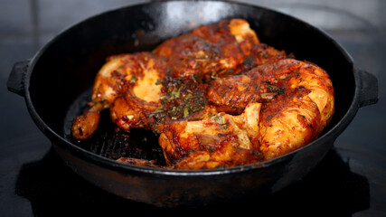 Appetizing grilled chicken in a cast iron pan.