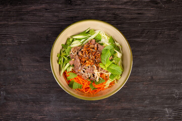 fresh salad with fresh greens, fresh vegetables, fried onions and boiled beef