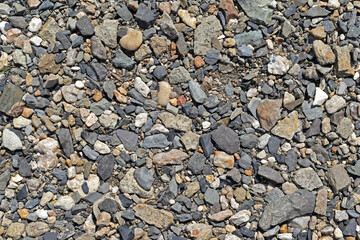 Large colorful pebbles and stones on the river bank