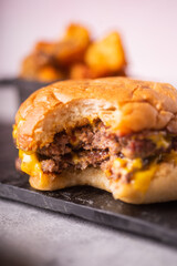 Bitten Cheese Burger with fries