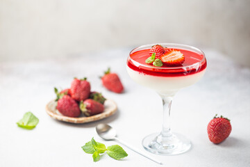 Italian panna cotta dessert with strawberry sirup and mint leaf