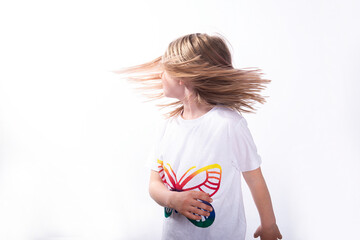 The little girl the blonde with flying hair. It is isolated on a white background